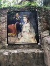 A Spanish fresco of a Mexican Princess and her husband sit outside the ruins of a mansion near a cenote in Mexico.