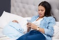 He was the size of a half loaf of bread. a mother using her phone while her baby sleeps at home. Royalty Free Stock Photo
