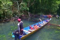 The guide is moving the long boat to parking area at Gunung Mulu National Park, Sarawak, Malaysia