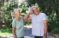 That was tough but we enjoyed it. a mature couple taking a break while exercising outdoors.