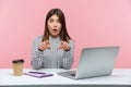 It was you? Extremely shocked brunette woman office worker in striped shirt sitting workplace, looking and pointing at camera with Royalty Free Stock Photo