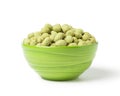 Wasabi crispy peanut snack balls in a green ceramic bowl isolated