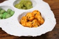 Wasabi rice snacks in a white bowl on wood background Royalty Free Stock Photo