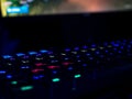 WASD gaming keyboard rgb lighting many colors with game in background