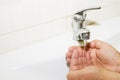 Wash basin and running water from the tap in bathroom Royalty Free Stock Photo