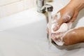 Wash basin and running water from the tap in bathroom Royalty Free Stock Photo