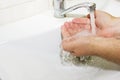 Wash basin and running water from the tap in bathroom Royalty Free Stock Photo
