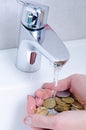 Wash basin and running water from the tap in chrome bathroom