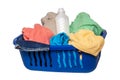 Wash basket isolated. Closeup of colorful dirty clothes and a white detergent bottle in a blue laundry basket isolated on a white