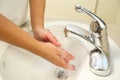 Wash hands, a man washes his hands under the tap with soap and water Royalty Free Stock Photo