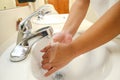 Wash hands, a man washes his hands under the tap with soap and water Royalty Free Stock Photo