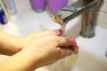 Wash hands with soap under a tap with water close-up. Hygiene concept. To prevent the coronavirus pandemic. Royalty Free Stock Photo
