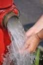 Wash Hands Under The Jet Of Water From A Fire Hydrant