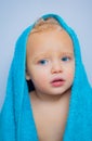 Wash infant hygiene and health and skin care. Little baby smiling under a white towel. Image of cute baby boy covered Royalty Free Stock Photo