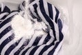 Wash a stain on white clothes under water stain powder for washing Royalty Free Stock Photo