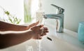 Wash, wash, wash your hands. Closeup shot of an unrecognisable boy washing his hands at a tap in a bathroom at home. Royalty Free Stock Photo