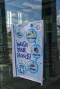 Wash your hands poster in a window of a school