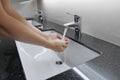 Washbasin and faucet on granite counter with hand washing Royalty Free Stock Photo