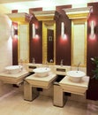 Washbasins, taps and mirror in public toilet Royalty Free Stock Photo