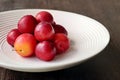 Washed cherry plums in a white porcelain bowl. Royalty Free Stock Photo