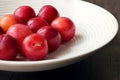 Washed cherry plums in a white porcelain bowl. Royalty Free Stock Photo