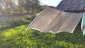 Washed clean laundry hanging on the rope or clothesline drying in the wind outdoors