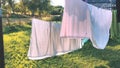 Washed clean laundry hanging on the rope or clothesline drying in the wind outdoors