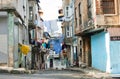 Washed clothes drying on a rope between historical houses of a street