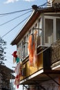 Washed linens drying on the balcony of the old house in the seas Royalty Free Stock Photo