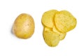 Washed potato lies next to several chips on a white background. The concept of comparing raw and finished product