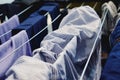 Washed shirt, pants and other clothes on the dryer. Everyday routine. Housework. Laundry Royalty Free Stock Photo
