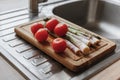 Washed tomatoes and asparagus on the board Royalty Free Stock Photo