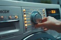 washer front panel close up person switch appliance program mode washing machine control panel Royalty Free Stock Photo