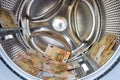 Washer inside with money Royalty Free Stock Photo