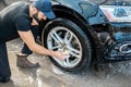 Washer wiping car wheel
