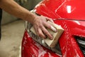 Washerman`s hand is washing car by sponge close up