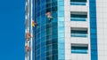 Washers wash the windows of modern skyscraper in Dubai timelapse