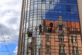 Washers wash the windows of modern skyscraper