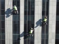 Washers wash the windows of modern skyscraper