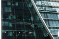 Washers wash the windows of modern skyscraper