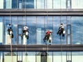 Washers wash the windows of skyscraper