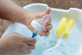 Washing baby nipples. Mother`s hand washing the baby nipples