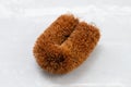 Washing brush made from coir fibre easy to hold, on ceramic background