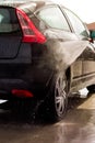 Washing a car with pressure washer