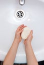 Washing child`s hands with antibacterial soap over the white sink. Protection against bacteria, coronavirus Royalty Free Stock Photo