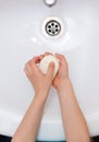 Washing child`s hands with antibacterial soap over the white sink. Protection against bacteria, coronavirus Royalty Free Stock Photo