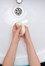 Washing child`s hands with antibacterial soap over the white sink. Protection against bacteria, coronavirus Royalty Free Stock Photo