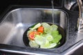 Washing colorful fruits and vegetables in the kitchen sink