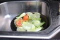 Washing colorful fruits and vegetables in the kitchen sink