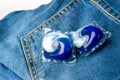 Washing detergent capsule pod on jeans Royalty Free Stock Photo